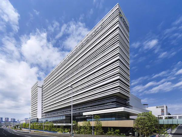 A modern hotel with a unique angular design and a prominent sign.